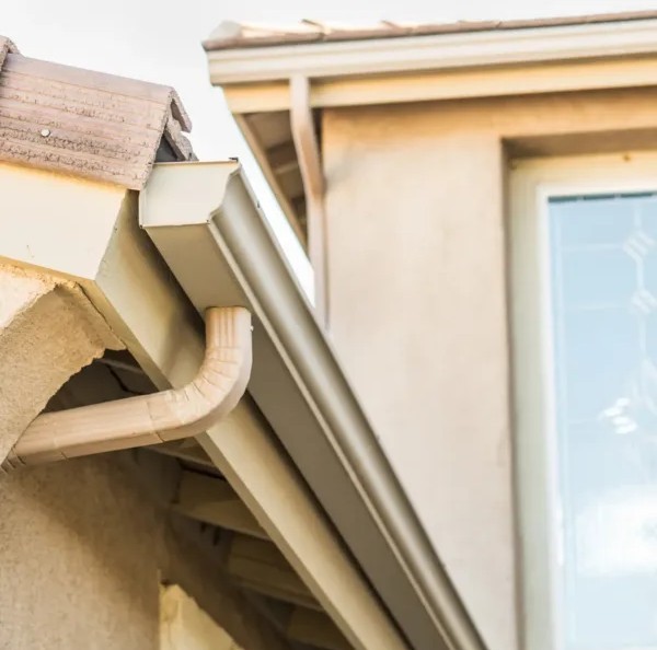 Side view of a new gutter installed by ASI Construction on a residential roof